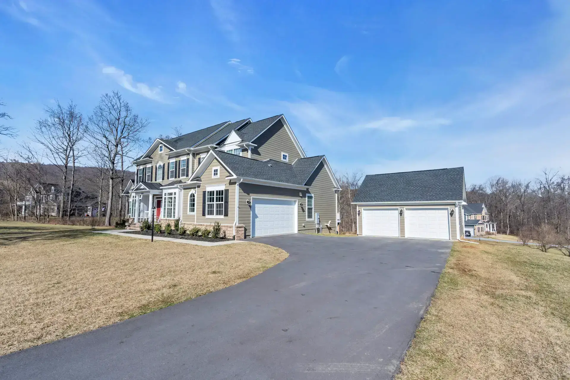 Two-story home with a new garage addition set well back from the road on a large Sterling, VA lot, built by Mosaic Design & Build